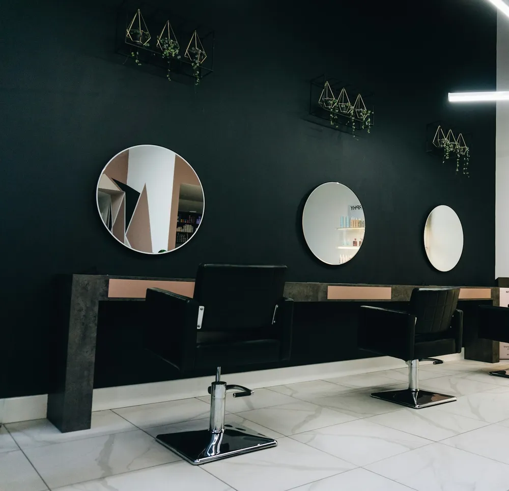 A salon with its chairs and mirrors ready for the day