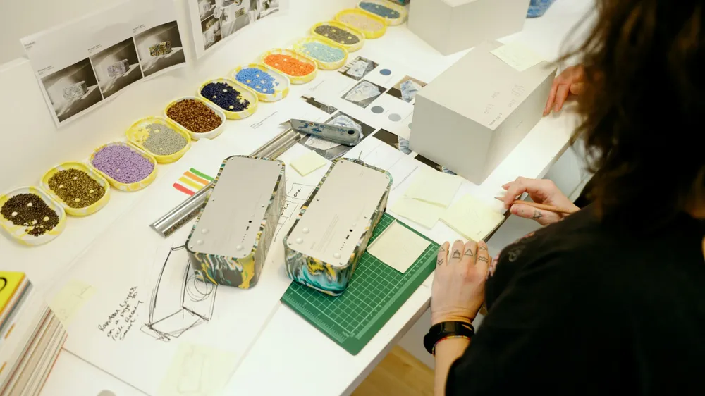 A designer working on models at a studio table